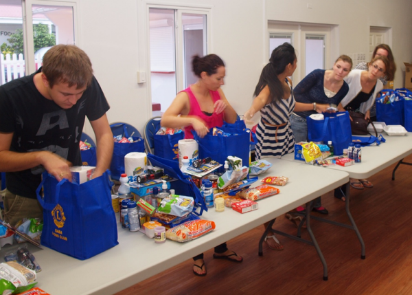 Student volunteers  of the  SUSOM’s Alpha Omega Phi Honour and Service Society fill the Hurricane Season Baskets for the Food Bank