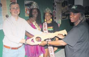 Island Governor Jonathan Johnson (left) handing over the symbolic key to the Carnival Village in The Bottom to Saba Cultural Foundation Treasurer Julietta Woods. Looking on are (from left) reigning Teen Carnival Queen Joelyn Rob- inson and Junior Carnival Queen Natalia Peterson.  (Daily Herald / Bob Morgan photo)