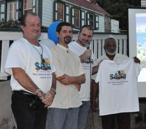 from l-r Director of Tourism Glenn Holm, Graphic Designer Malachy Magee, Commissioner of Tourism, Chris Johnson and Chairman of the Saba Day Committee, Dave Levenstone, displaying the T-shirts with the new identity. (Photo GIS Saba)