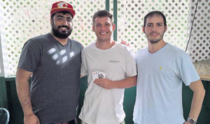 Poker-tournament winner Michael Atkinson (centre) with organisers Robby Sahi (left) and Daniel Gomez.