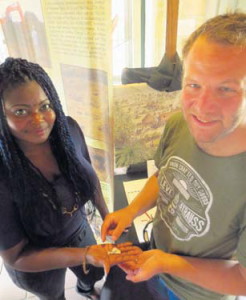 Historical Museum guide Misha Spanner (left) handing over the fragments to archaeologist Joost Morsink, who will bring them to St. Maarten and Saba.
