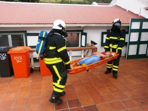 Firefighters transport a victim during the simulated exercise.