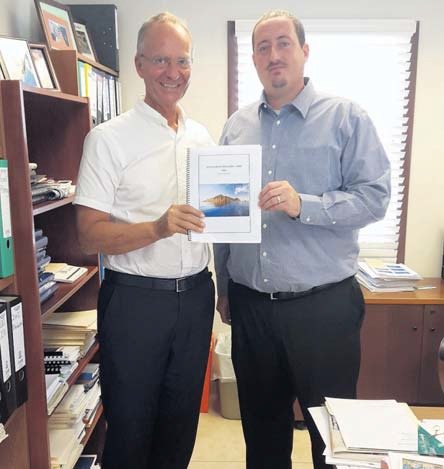Saba Commissioner Bruce Zagers (right) hands over the Tourism Action Plan 2016-2018 to Dutch Minister of Economic Affairs Henk Kamp on Monday.